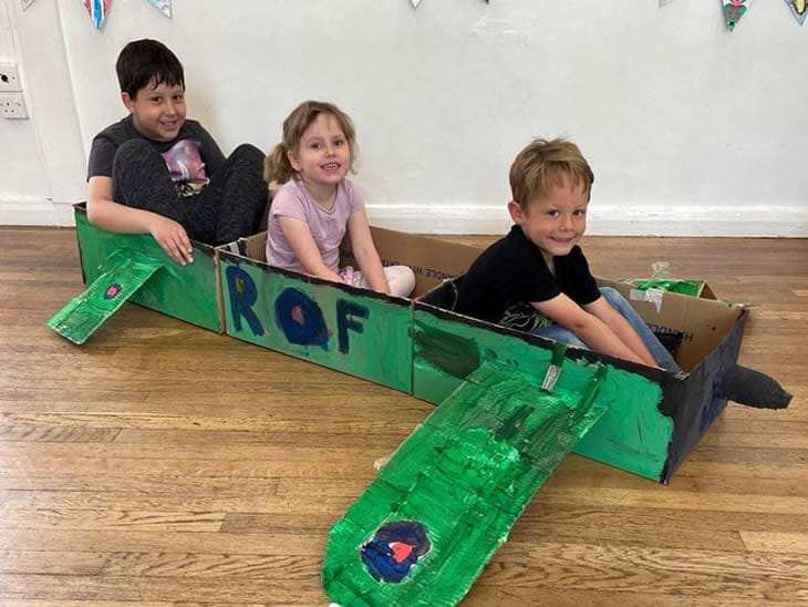 Children in their Spitfire model plane